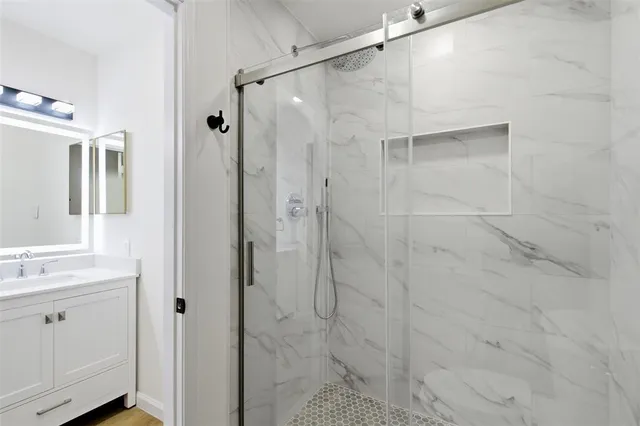 a bathroom with a shower and a sink