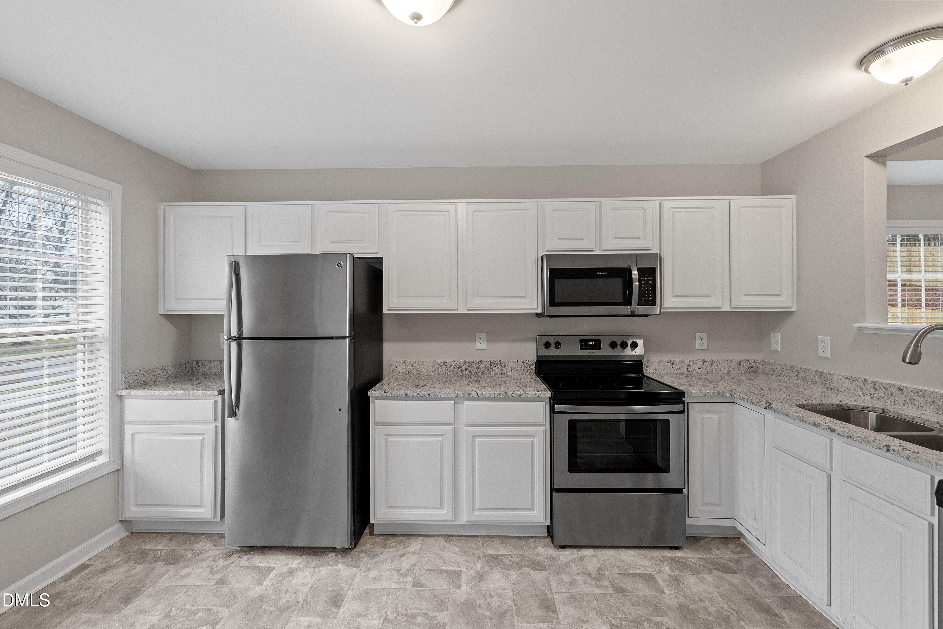 140 Melksham Road Wake Forest, NC 27587 - Photo 12 of 34 a kitchen with a refrigerator stove and microwave