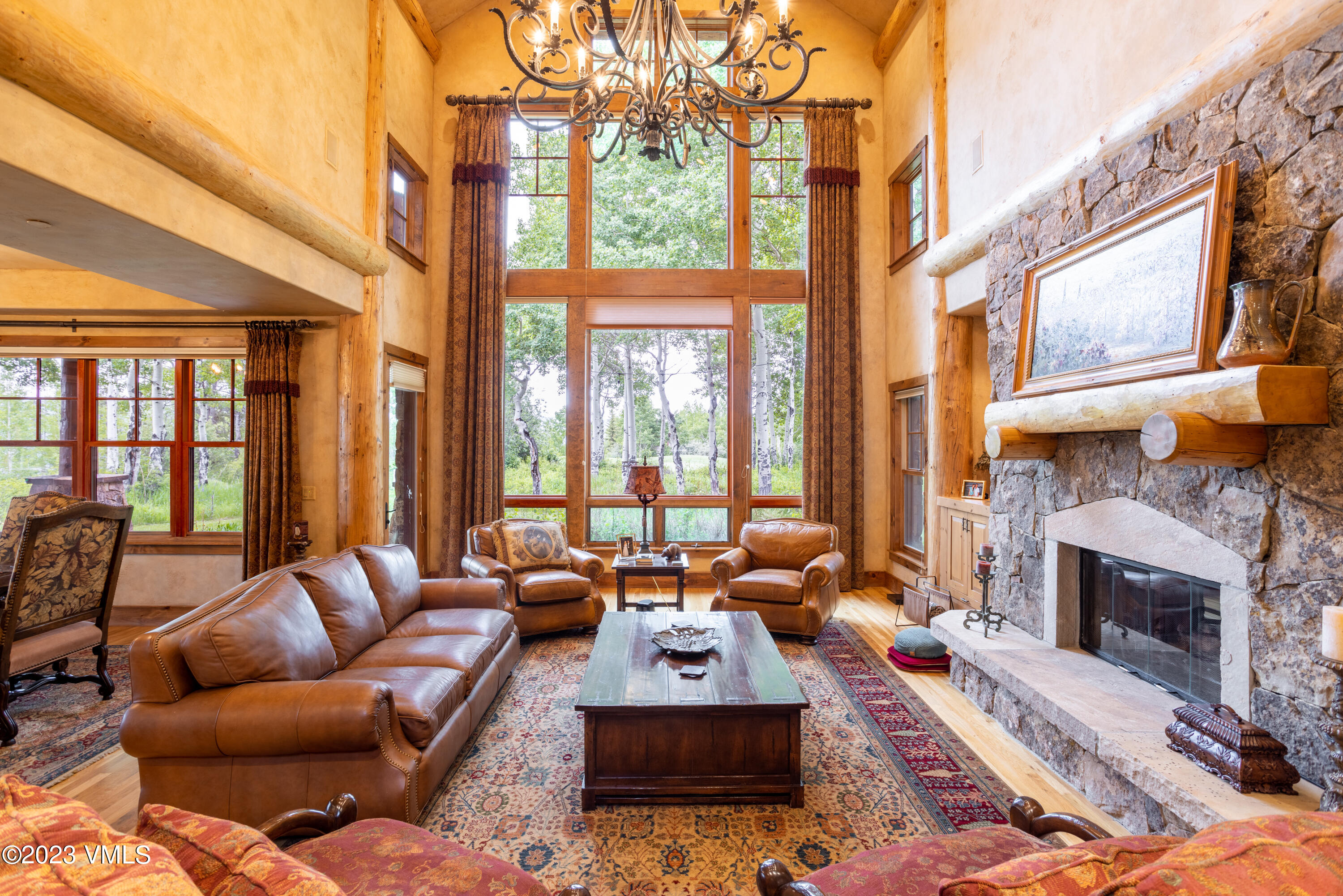 67 Cimarron Trail Edwards, CO 81632 - Photo 14 of 51 a living room with furniture a fireplace and floor to ceiling windows