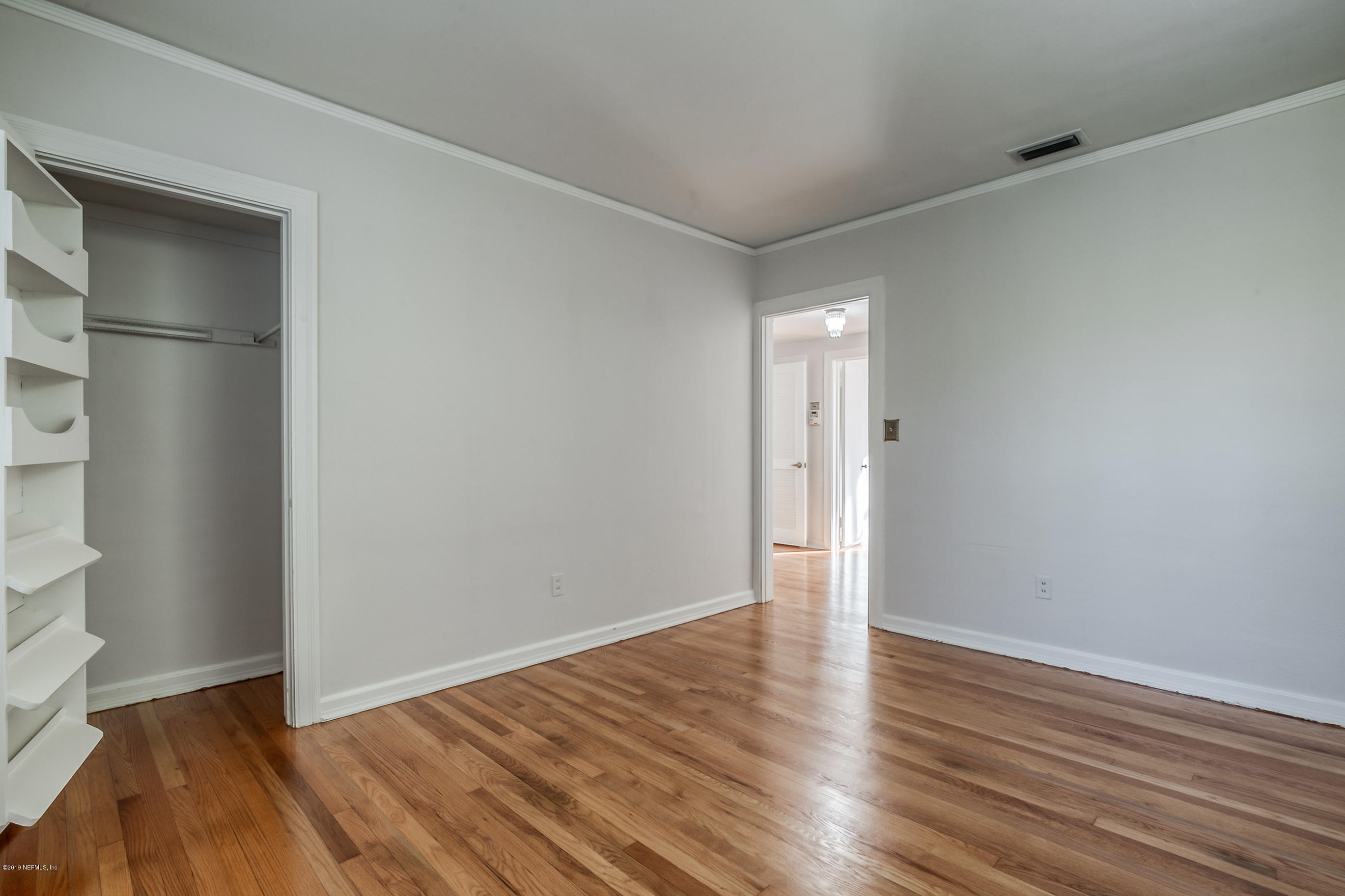 1024 Chatford Road Jacksonville, FL 32207 - Photo 13 of 22 a view of an empty room with wooden floor and a window