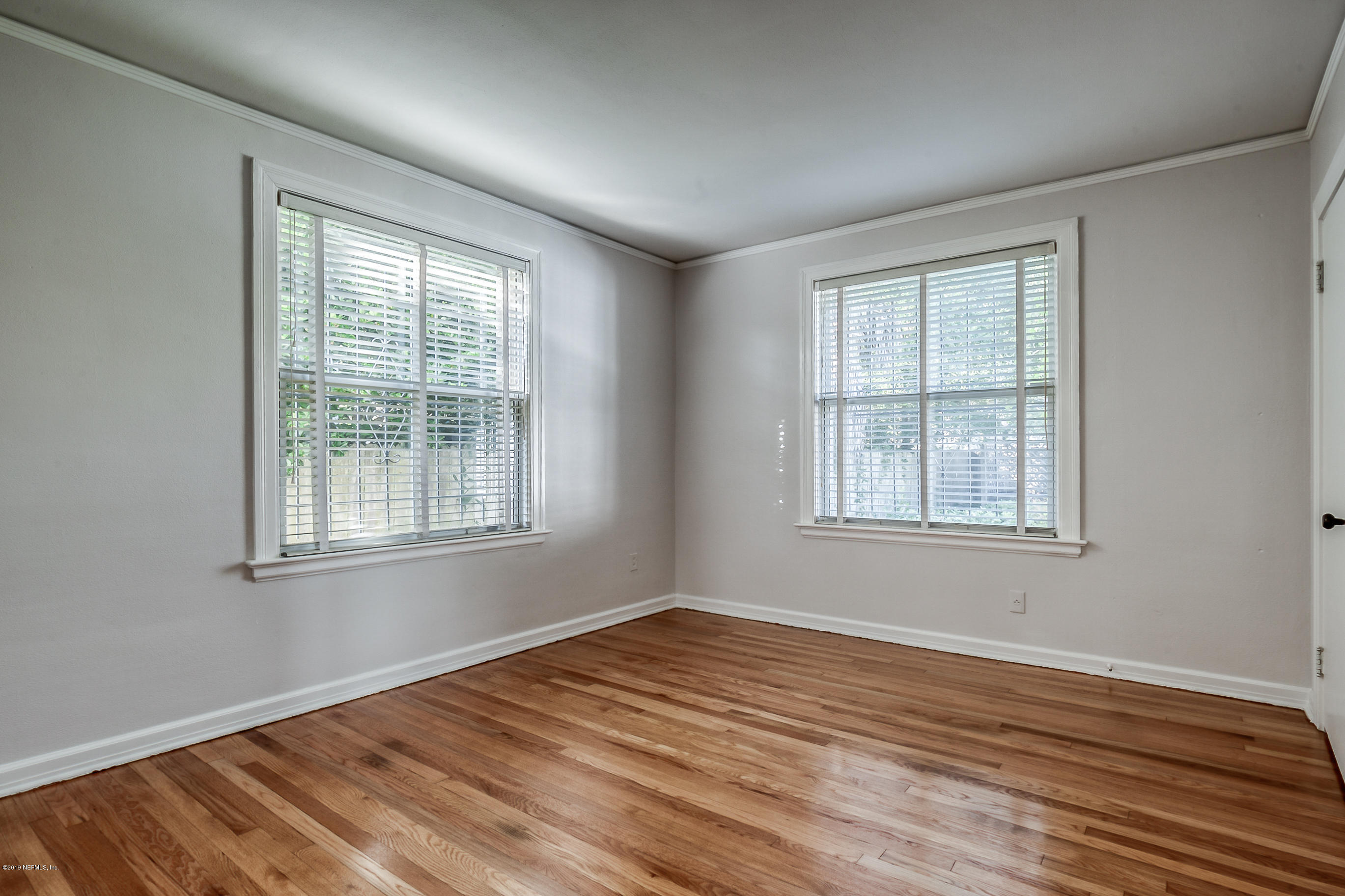 1024 Chatford Road Jacksonville, FL 32207 - Photo 15 of 22 an empty room with wooden floor and windows