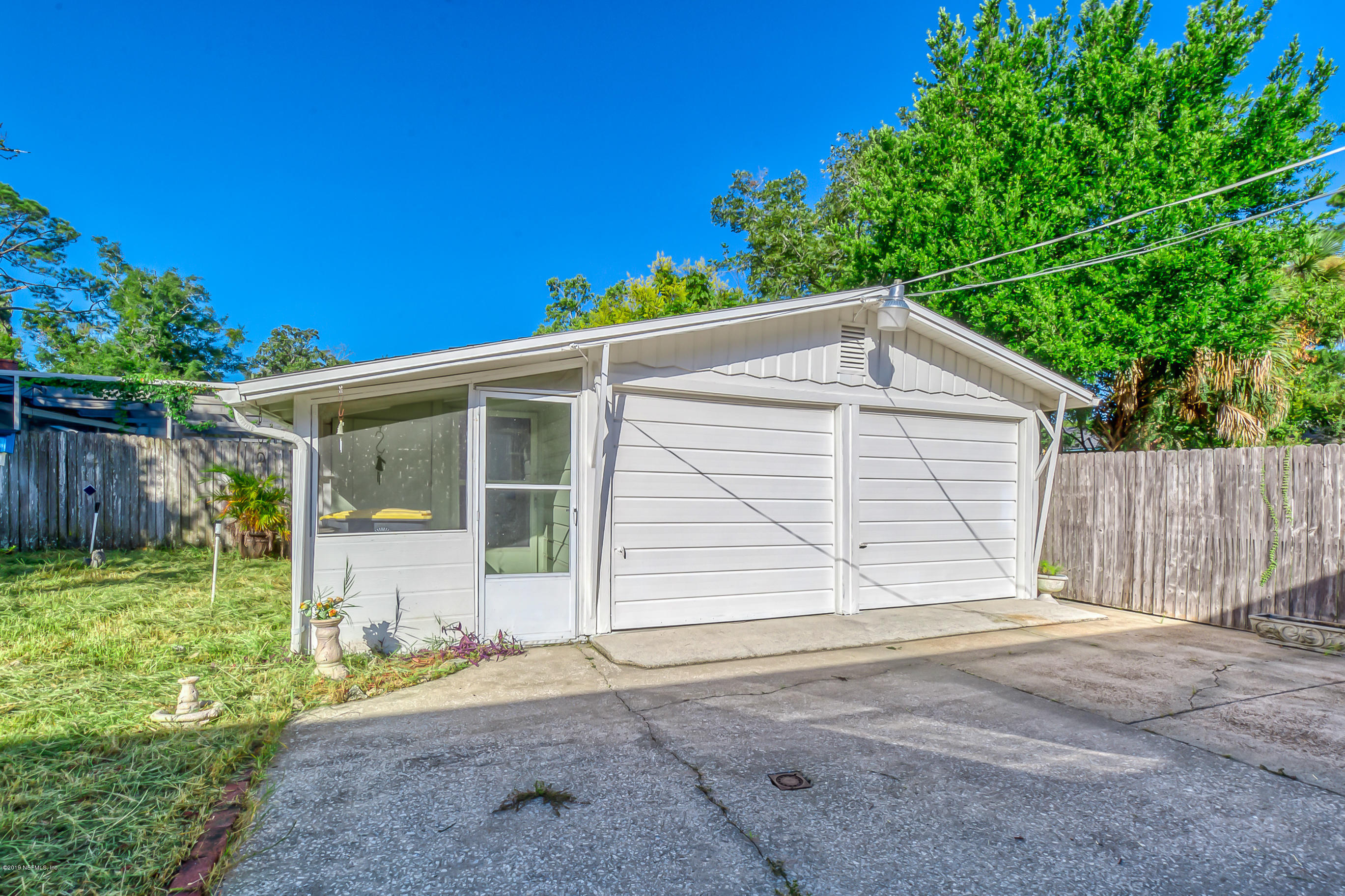 1024 Chatford Road Jacksonville, FL 32207 - Photo 19 of 22 a view of a house with a yard and garage