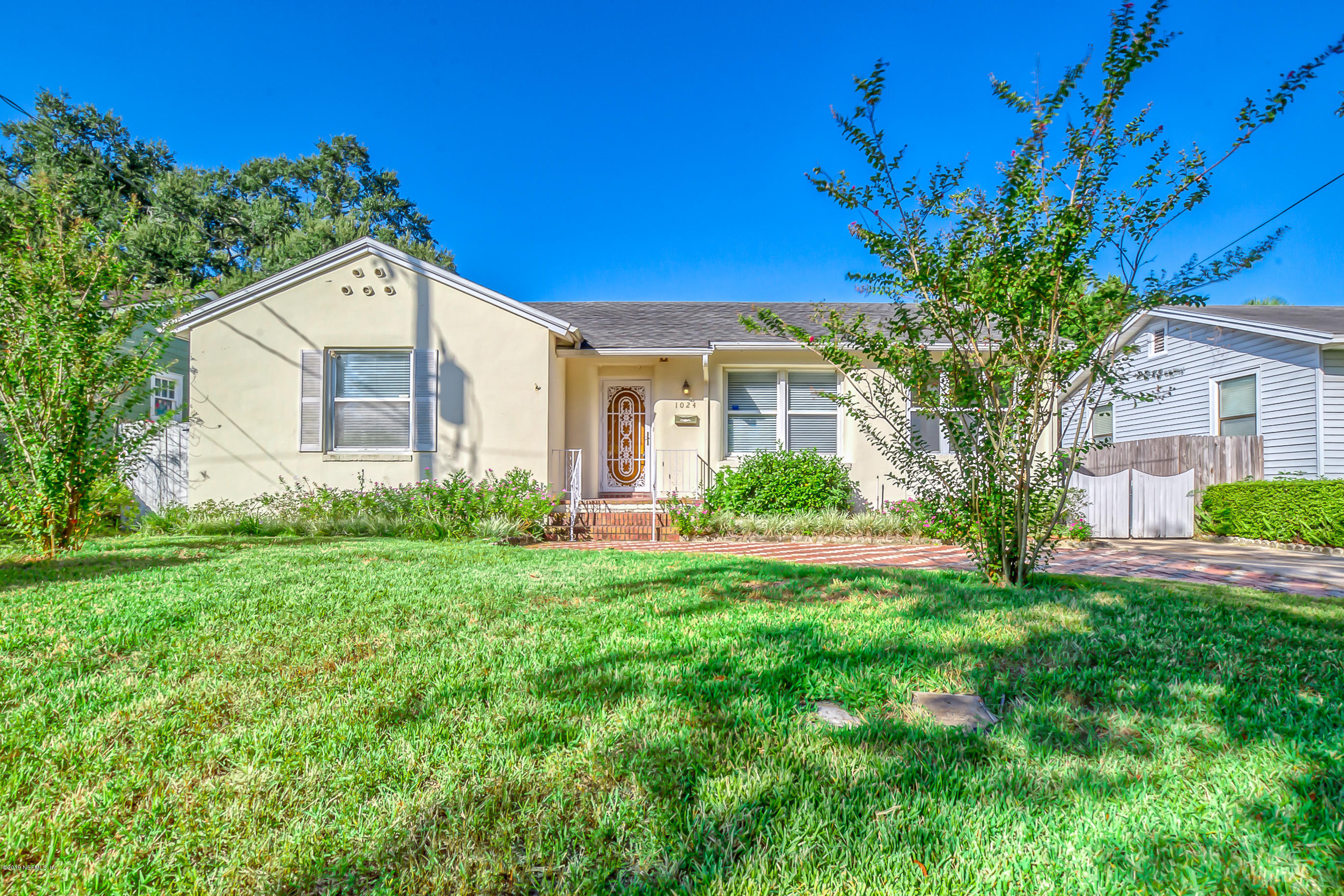 1024 Chatford Road Jacksonville, FL 32207 - Photo 20 of 22 a front view of a house with a yard and garage