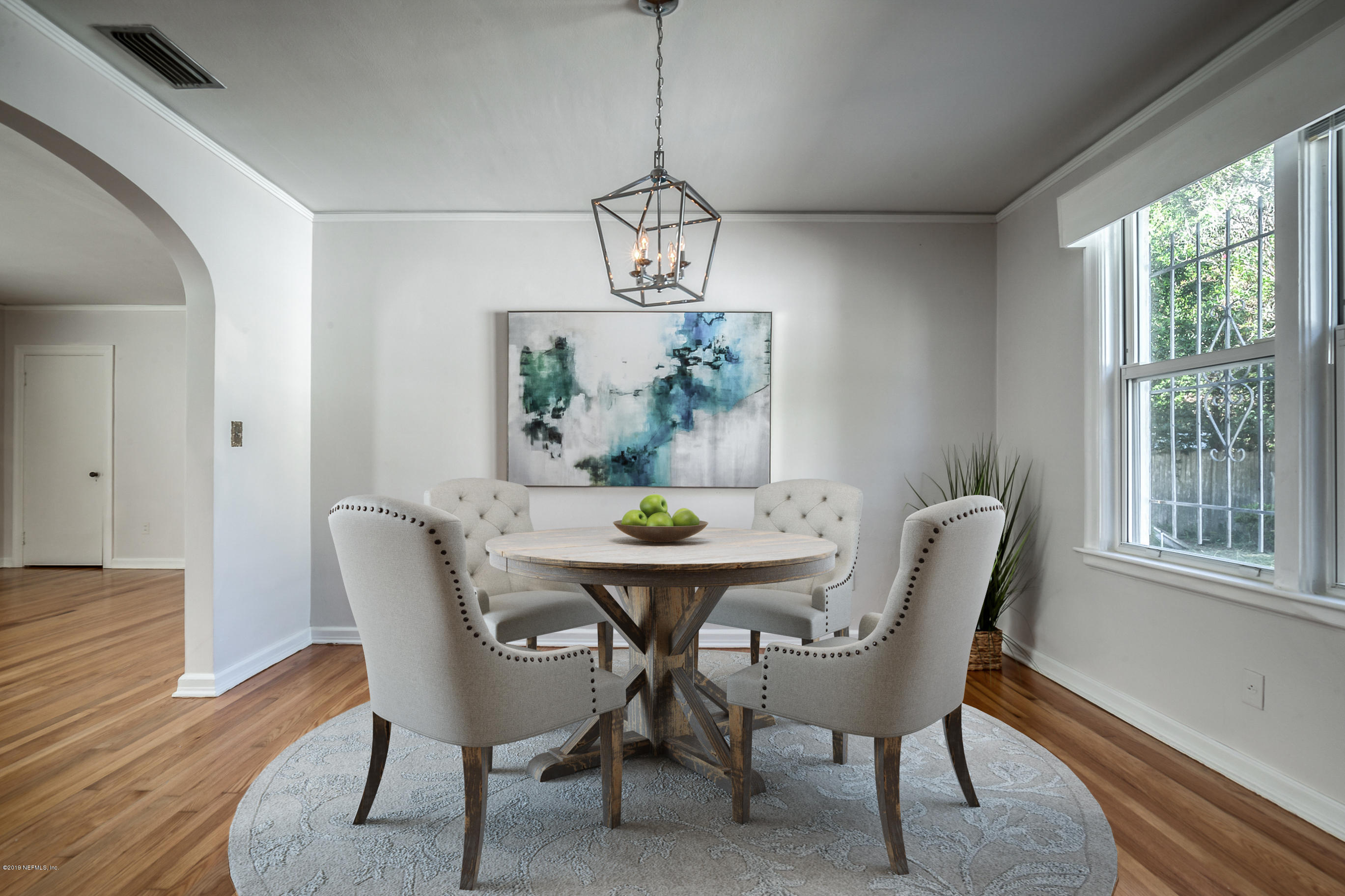 1024 Chatford Road Jacksonville, FL 32207 - Photo 4 of 22 a dining room with furniture a chandelier and wooden floor
