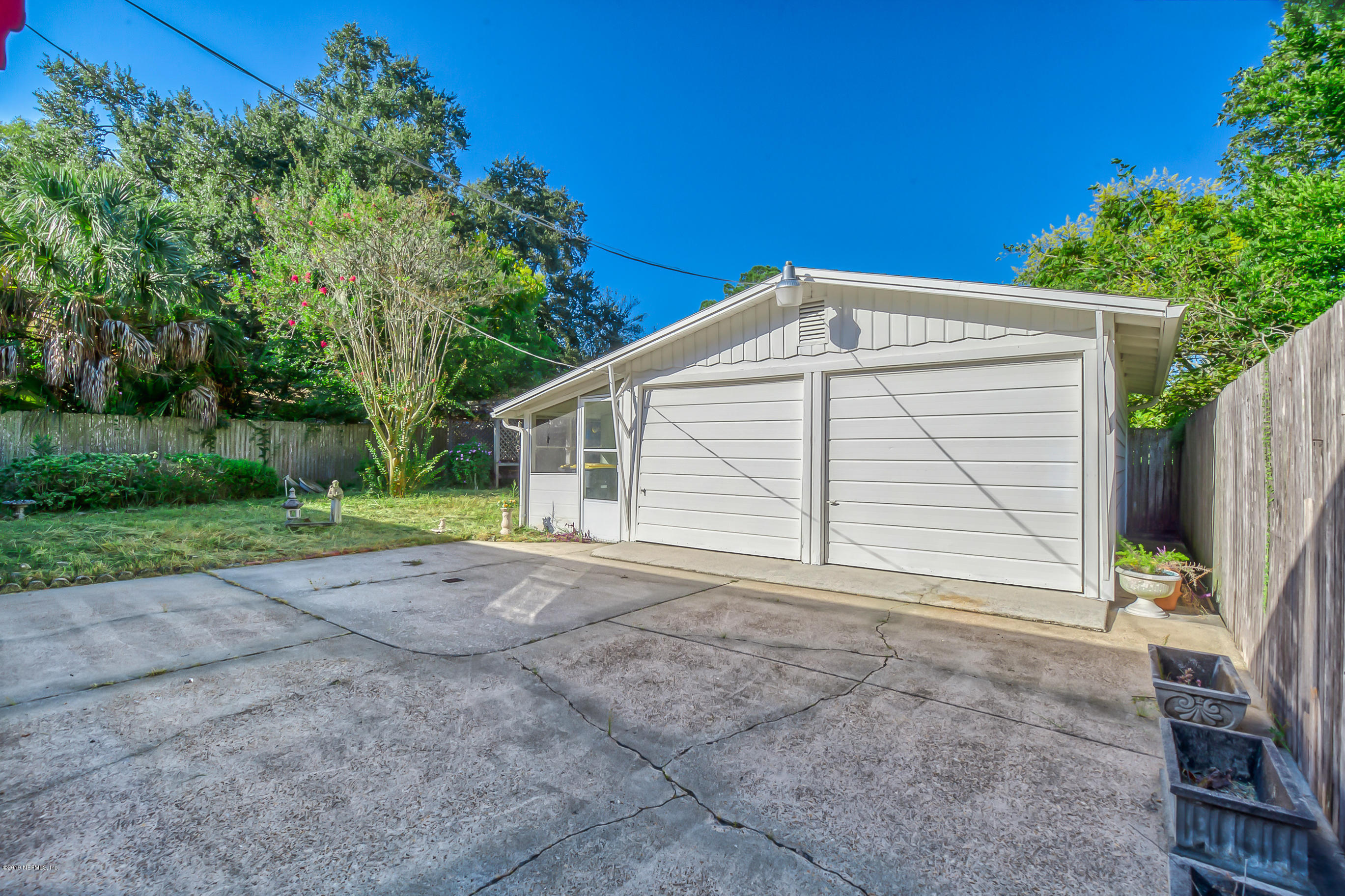 1024 Chatford Road Jacksonville, FL 32207 - Photo 7 of 22 a view of a house with a backyard and garage