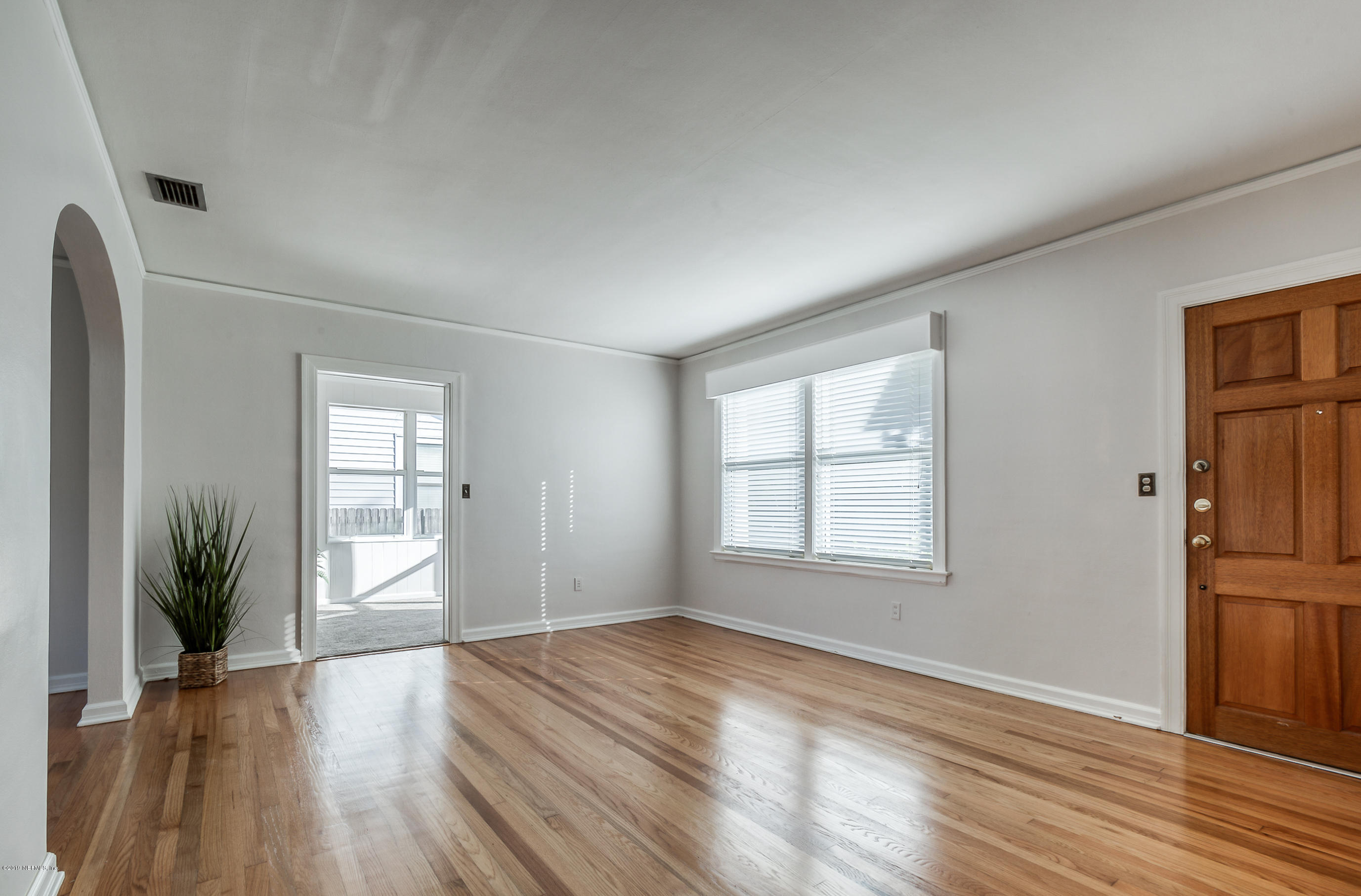 1024 Chatford Road Jacksonville, FL 32207 - Photo 8 of 22 an empty room with wooden floor and windows