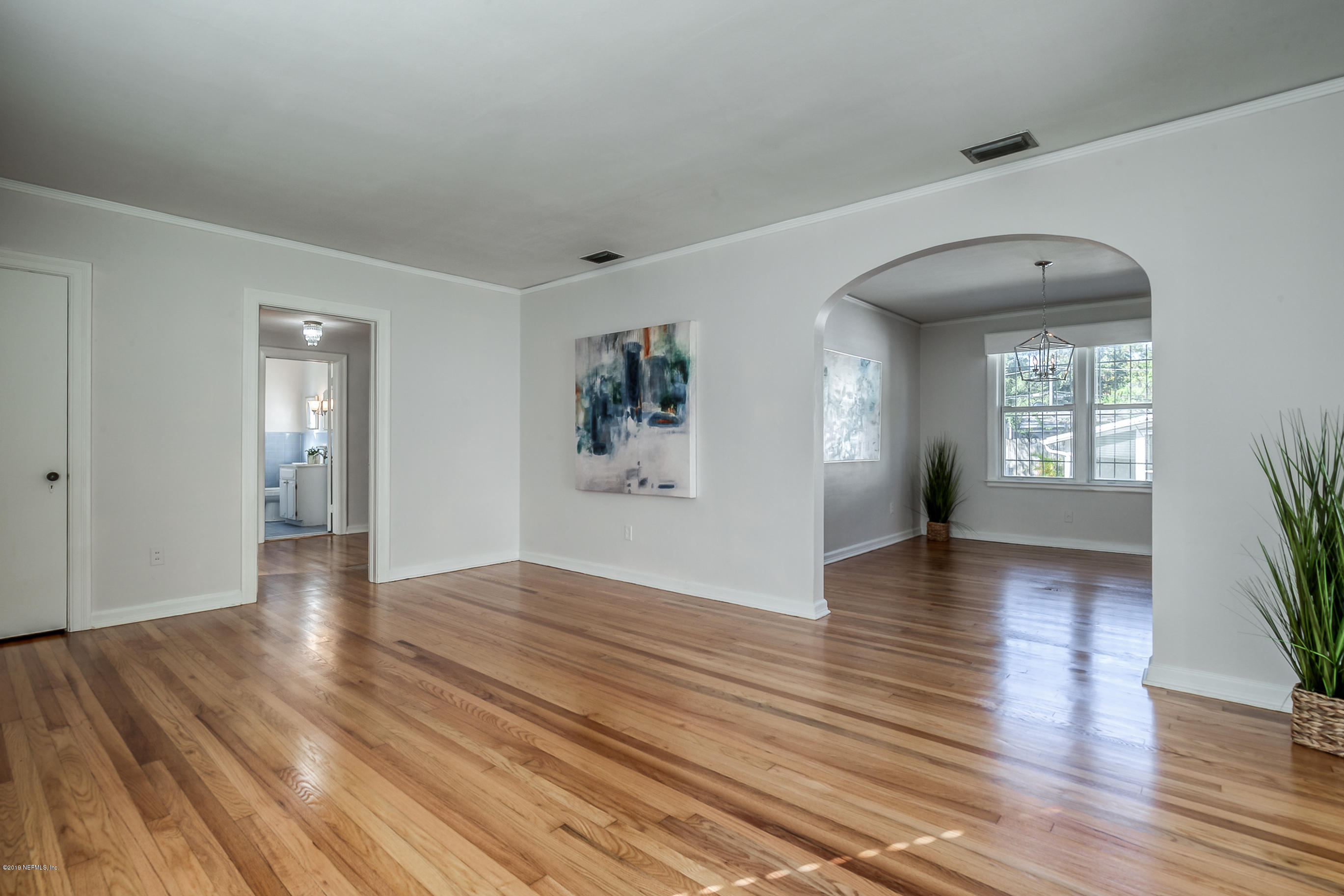 1024 Chatford Road Jacksonville, FL 32207 - Photo 9 of 22 a view of an empty room with window and wooden floor