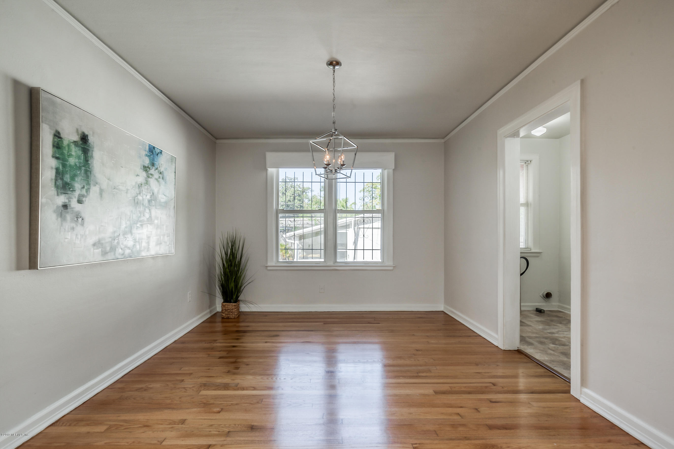 1024 Chatford Road Jacksonville, FL 32207 - Photo 10 of 22 wooden floor in an empty room with a window