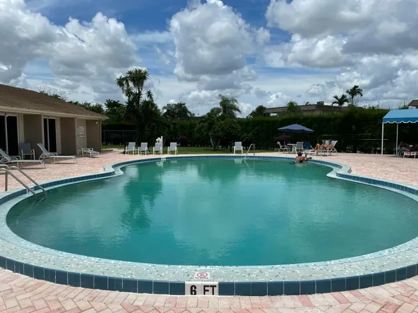a view of a swimming pool with a yard