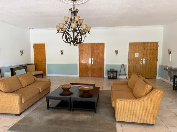 a living room with furniture and a chandelier