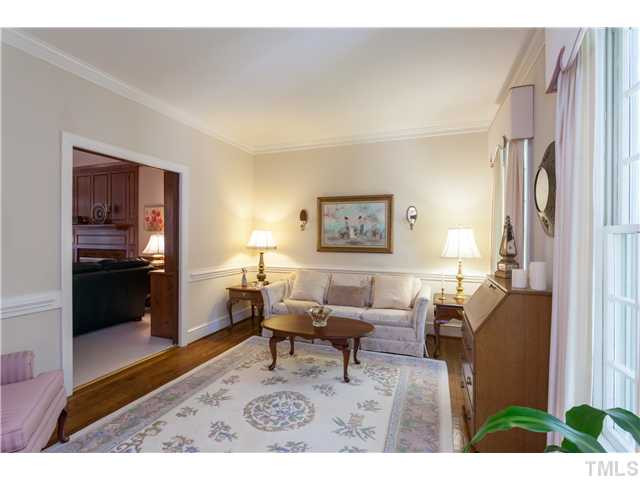 12405 Whartons Way Raleigh, NC 27613 - Photo 4 of 23 BRIGHT AND OPEN LIVING ROOM WITH HARDWOODS AND CHAIR AND CROWN MOLDINGS. RELAX YOUR DAY AWAY IN THIS PEACEFUL SETTING. Living Room