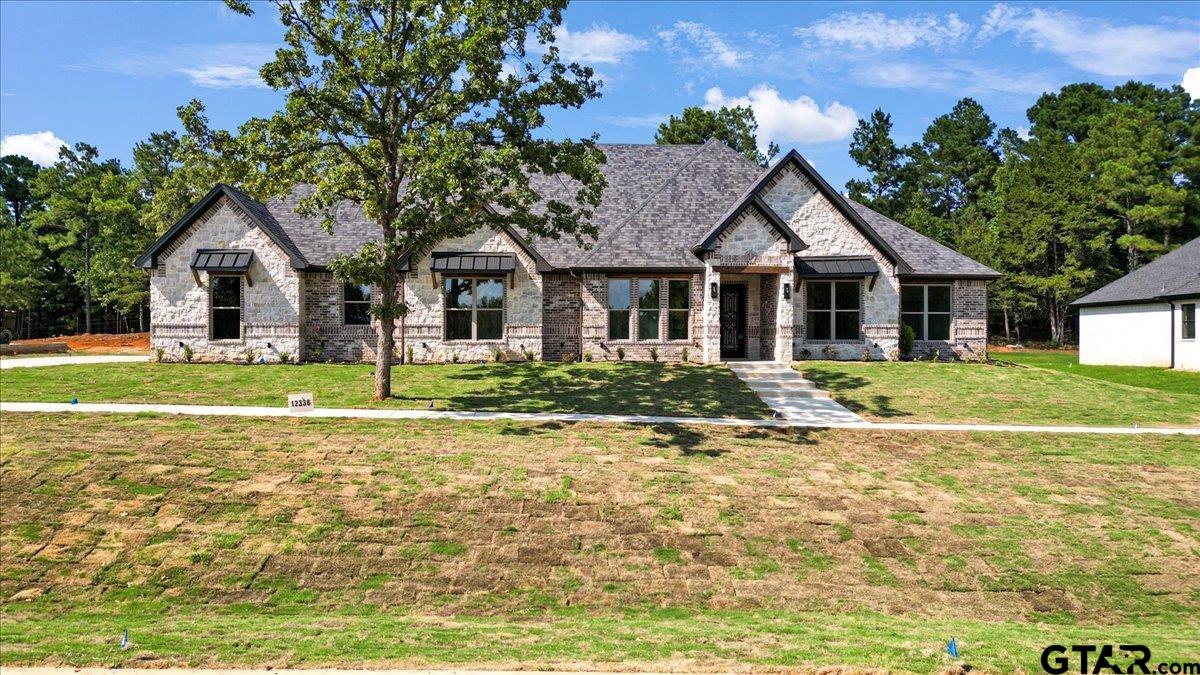12336 Oak Grove Drive Lindale, TX 75706 - Photo 1 of 46 a front view of a house with a yard and trees