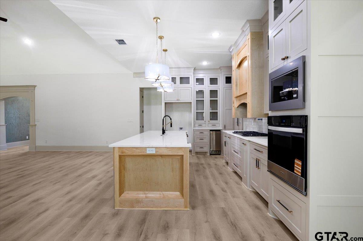 12336 Oak Grove Drive Lindale, TX 75706 - Photo 12 of 46 a kitchen with stainless steel appliances a stove a sink and a refrigerator