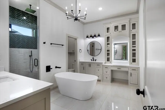 a large spacious bathroom with a double vanity sink mirror and bathtub