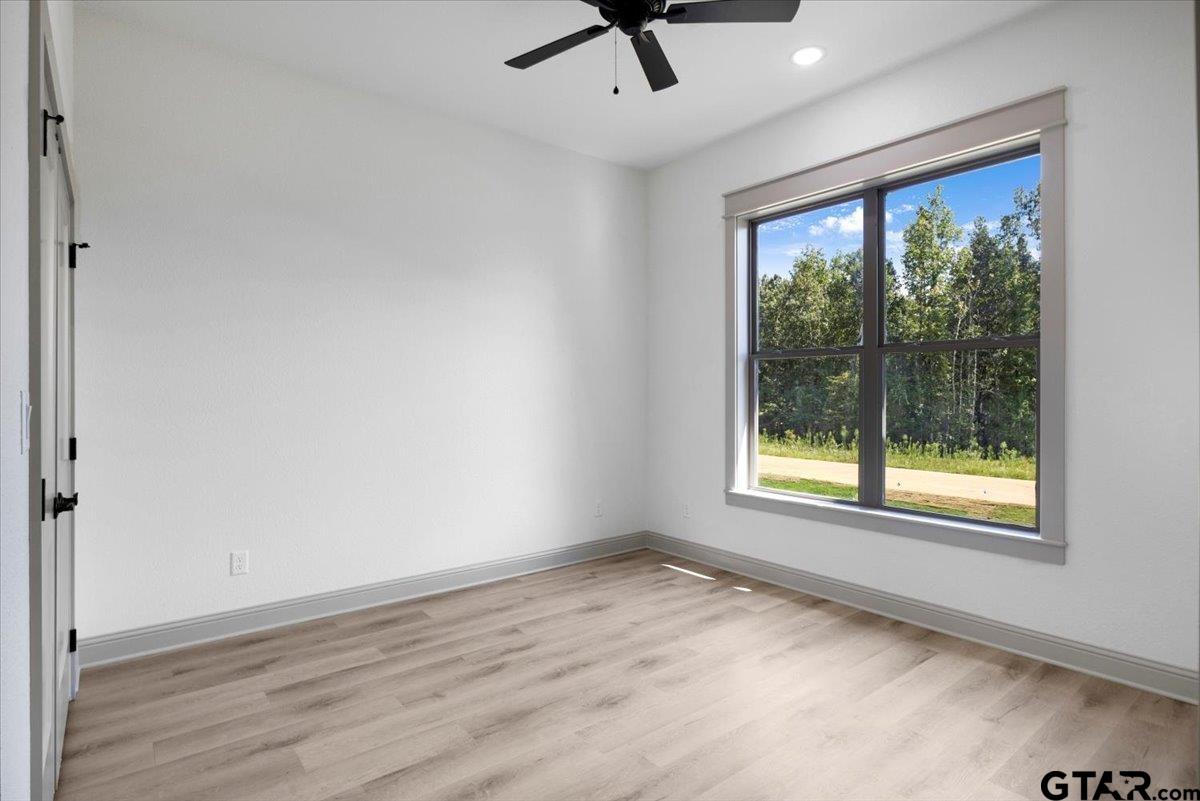 12336 Oak Grove Drive Lindale, TX 75706 - Photo 31 of 46 wooden floor in an empty room with a window