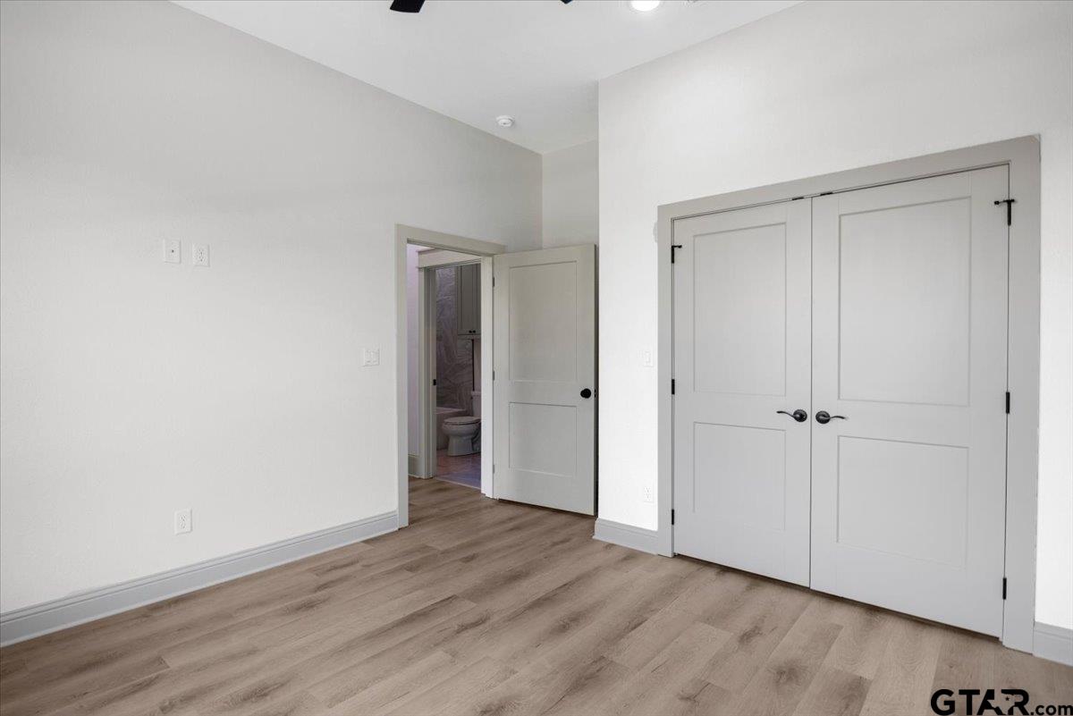 12336 Oak Grove Drive Lindale, TX 75706 - Photo 33 of 46 a view of an empty room and wooden floor & entryway