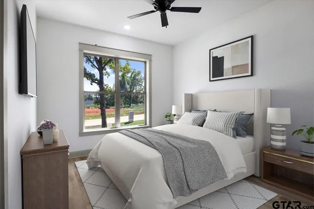 a bedroom with a bed and wooden floor