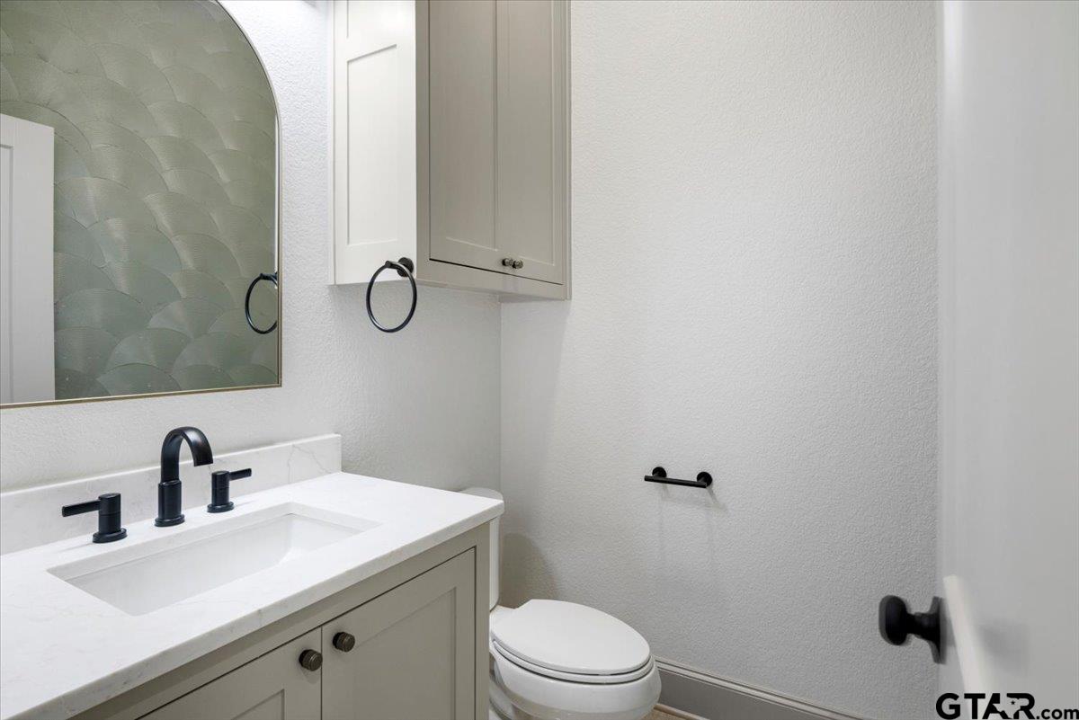 12336 Oak Grove Drive Lindale, TX 75706 - Photo 43 of 46 a bathroom with a sink a toilet and shower