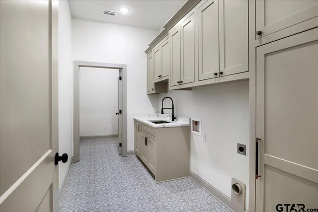 a view of a storage and utility room with a sink
