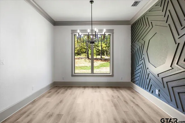 a room with window wooden floor and a chandelier