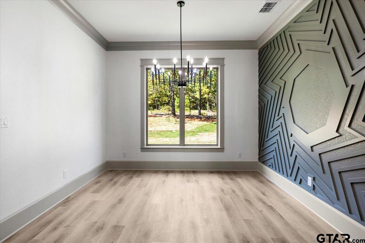 12336 Oak Grove Drive Lindale, TX 75706 - Photo 46 of 46 a room with window wooden floor and a chandelier