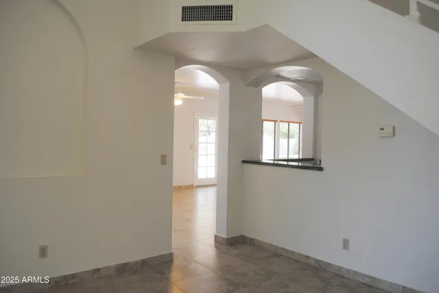 an empty room with windows and wooden floor