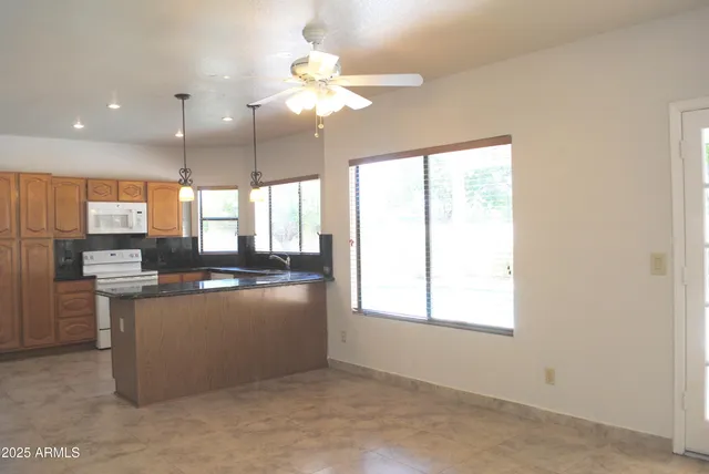 a kitchen with kitchen island stainless steel appliances a large counter top and stove