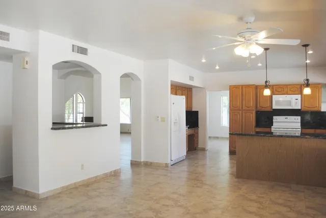 a view of a kitchen with a sink and a refrigerator