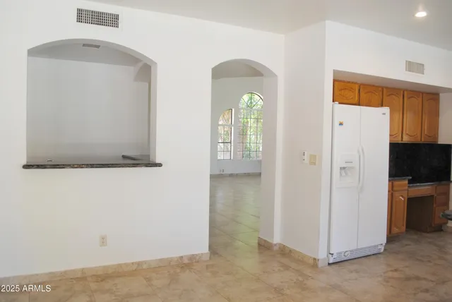 a view of a room that has a bed and a dresser in it