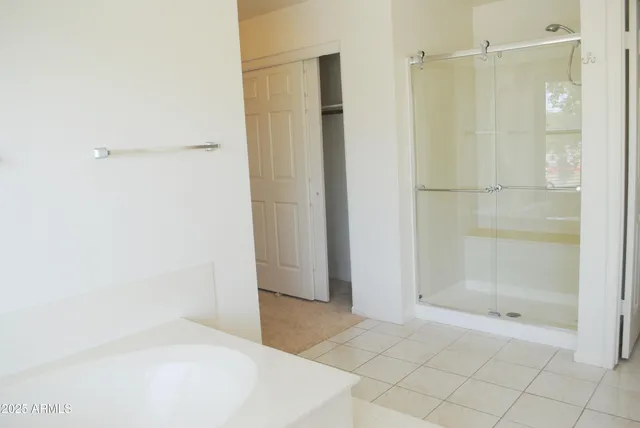 a spacious bathroom with a tub and a sink