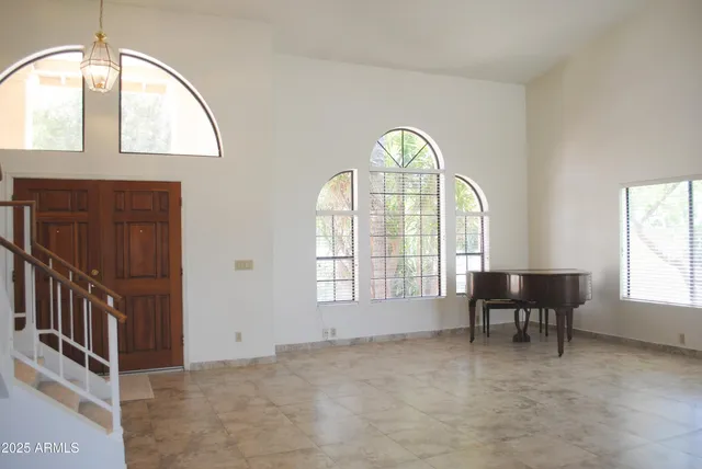 an empty room with windows swimming pool and outdoor view