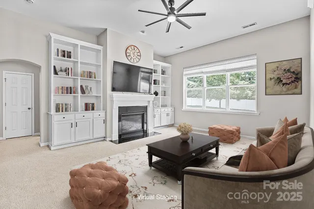 a living room with furniture and a fireplace