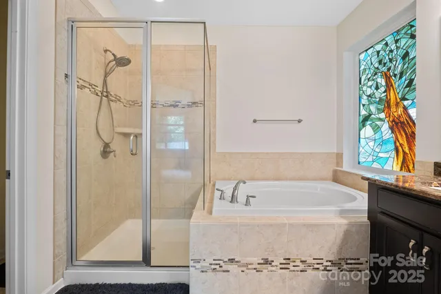 a bathroom with a bathtub and a shower