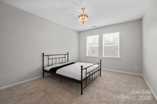 a bed room with a bed and a window