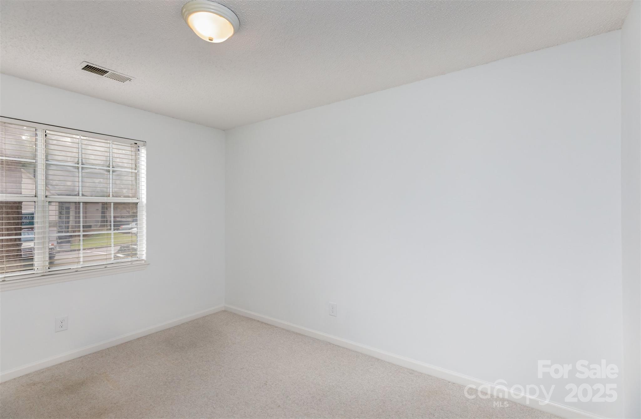 1021 Churchill Downs Court, Unit G Charlotte, NC 28211 - Photo 16 of 37 an empty room with a window