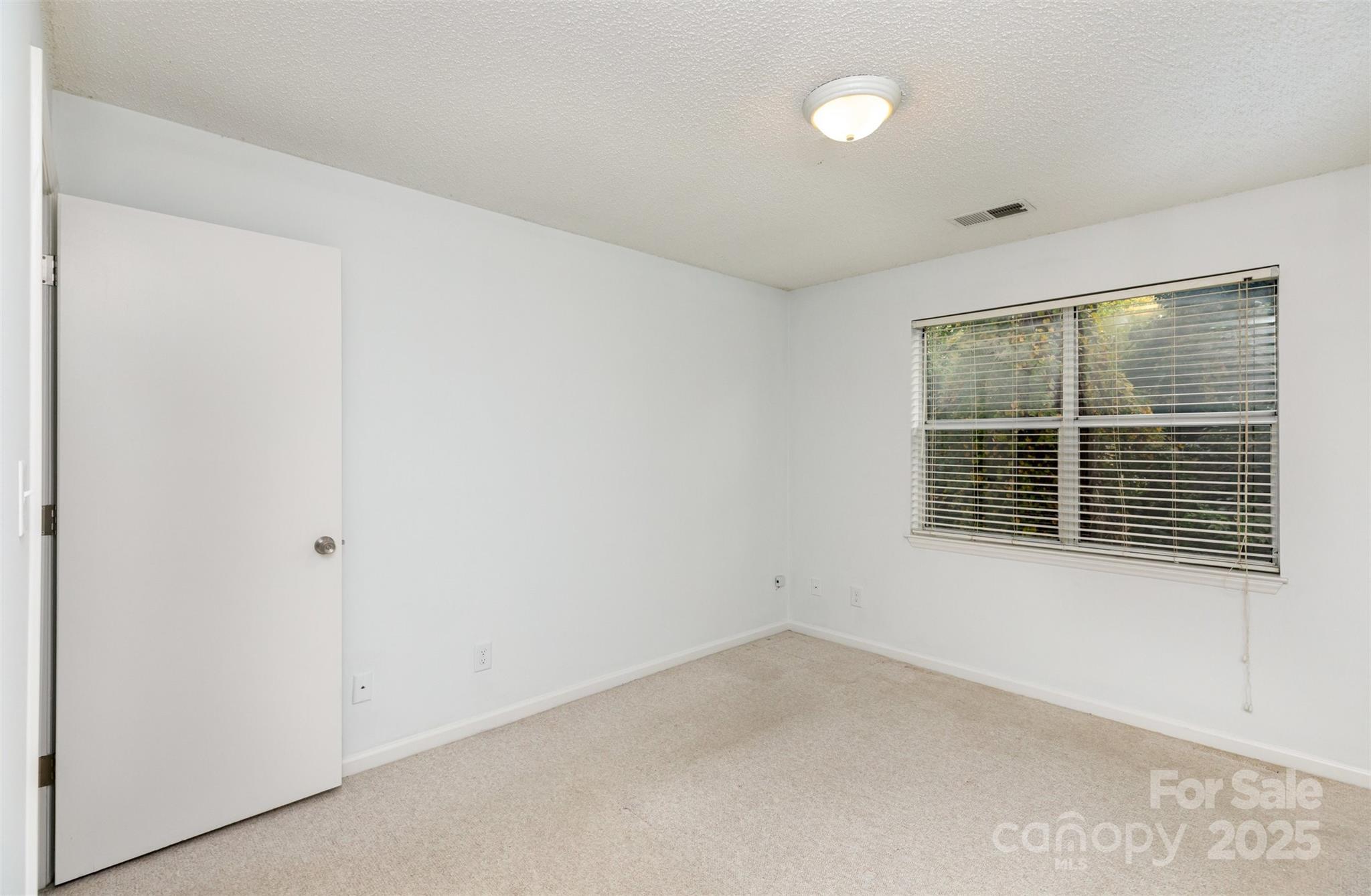 1021 Churchill Downs Court, Unit G Charlotte, NC 28211 - Photo 19 of 37 a view of an empty room with a window