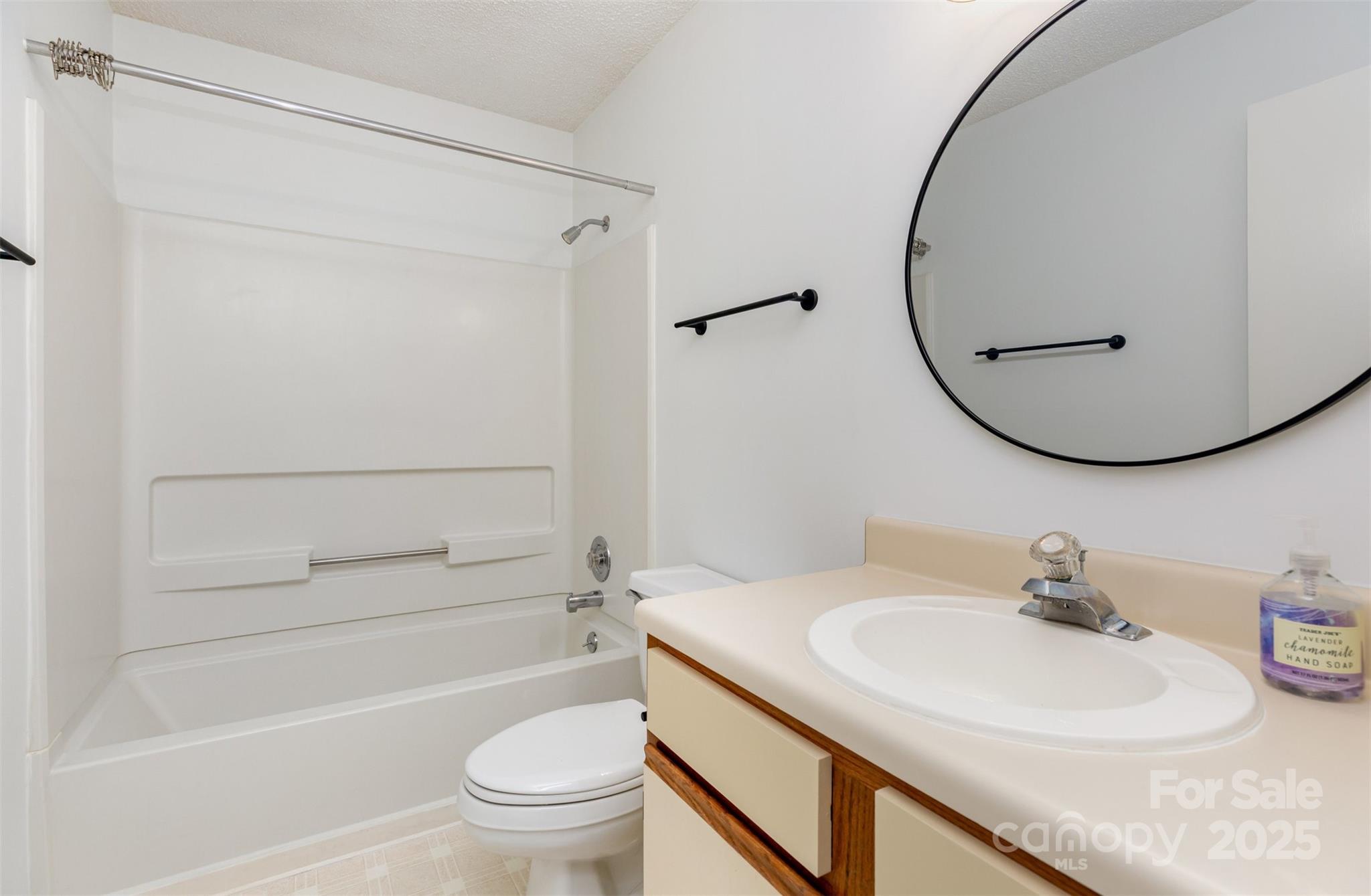 1021 Churchill Downs Court, Unit G Charlotte, NC 28211 - Photo 22 of 37 a bathroom with a sink a toilet and a mirror