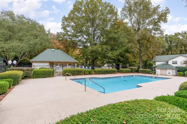 a view of a house with swimming pool and sitting area