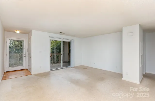 a view of an empty room with glass door