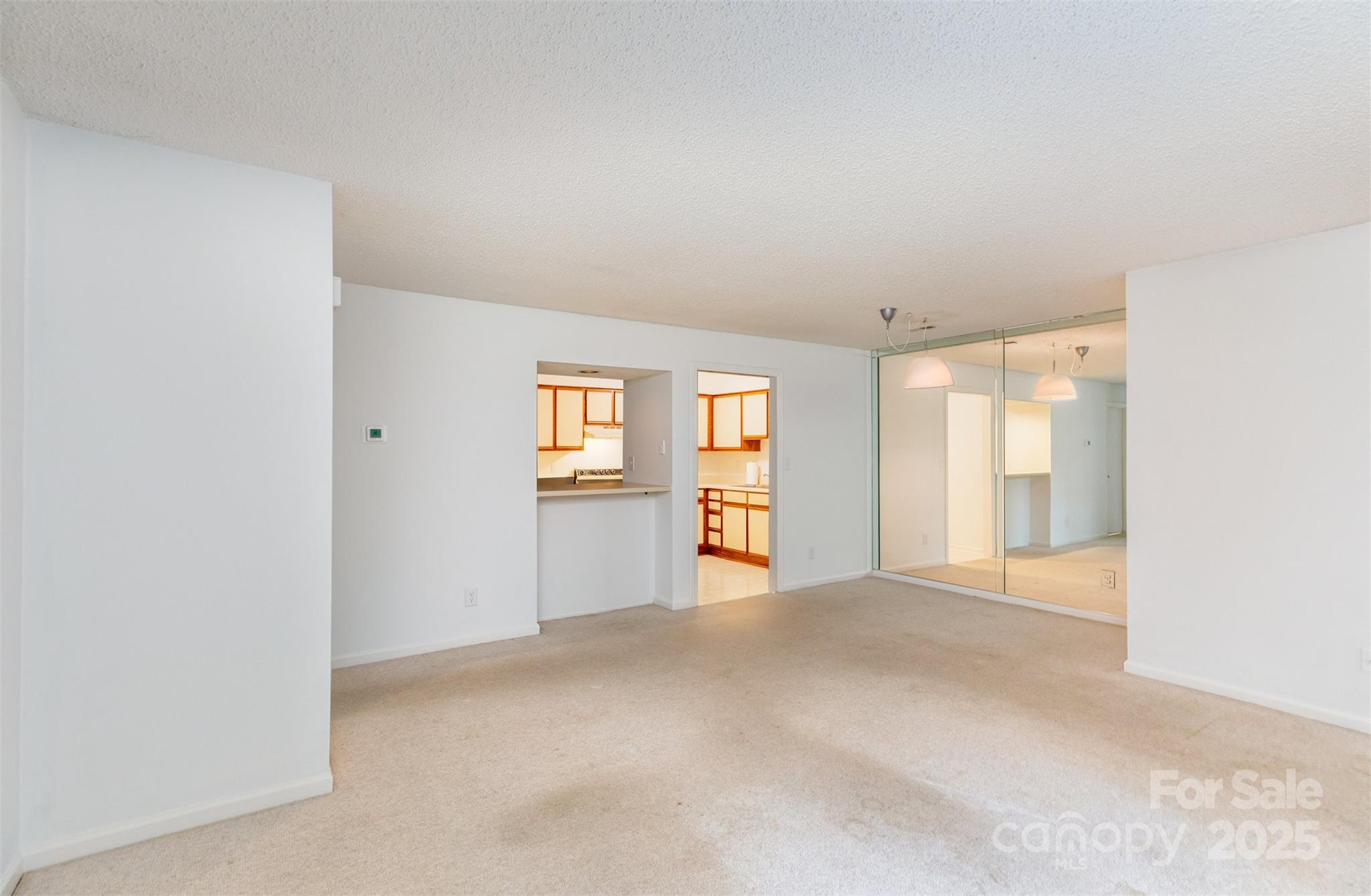 1021 Churchill Downs Court, Unit G Charlotte, NC 28211 - Photo 6 of 37 a view of an empty room with window and wooden floor