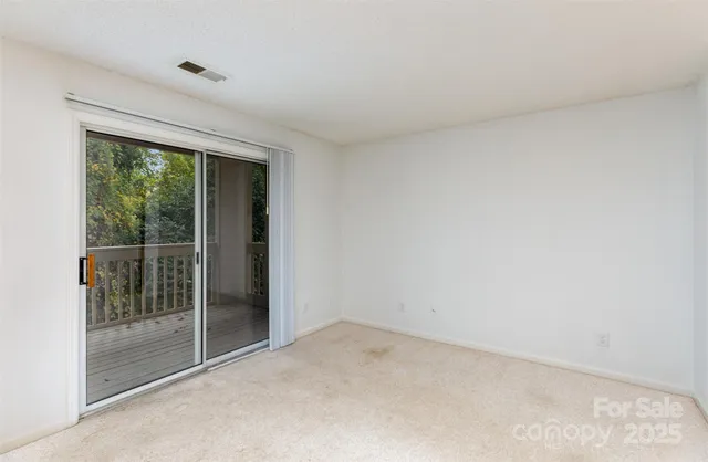 a view of an empty room with glass door