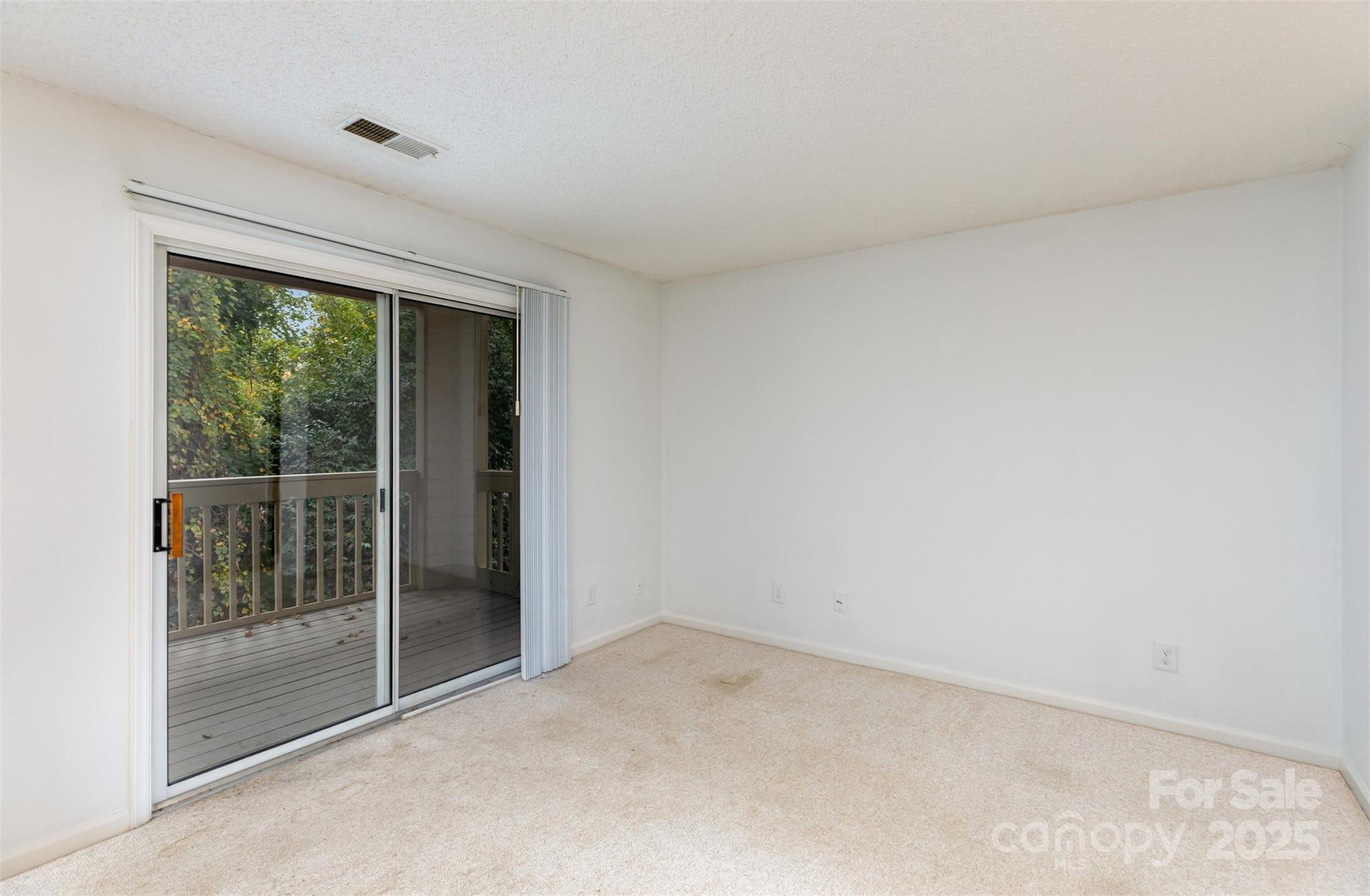 1021 Churchill Downs Court, Unit G Charlotte, NC 28211 - Photo 8 of 37 a view of an empty room with glass door