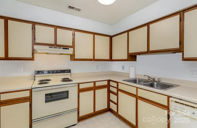a kitchen with stainless steel appliances a stove sink and cabinets