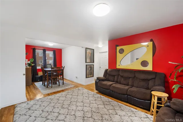 a living room with furniture and a dining table