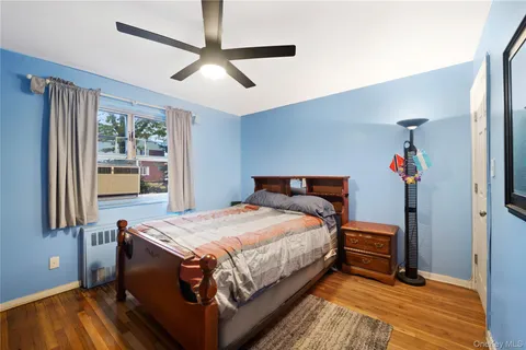 a bedroom with bed and wooden floor