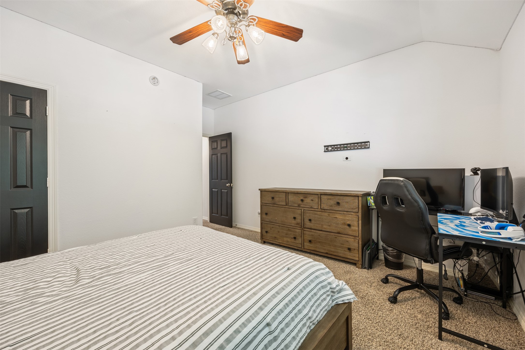58 South Longsford Circle Spring, TX 77382 - Photo 12 of 50 a bedroom with a bed and a chandelier