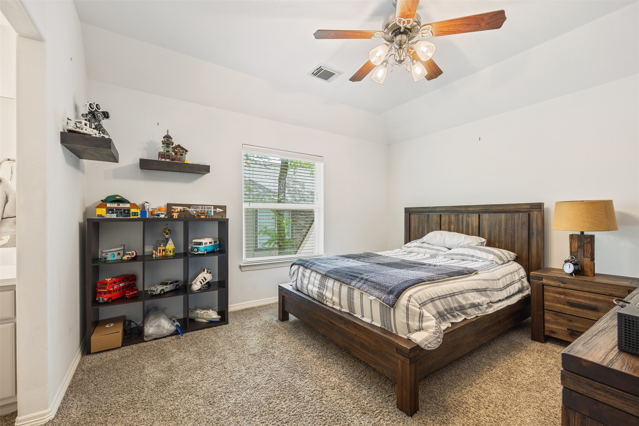 58 South Longsford Circle Spring, TX 77382 - Photo 21 of 50 a bedroom with a bed and a chandelier
