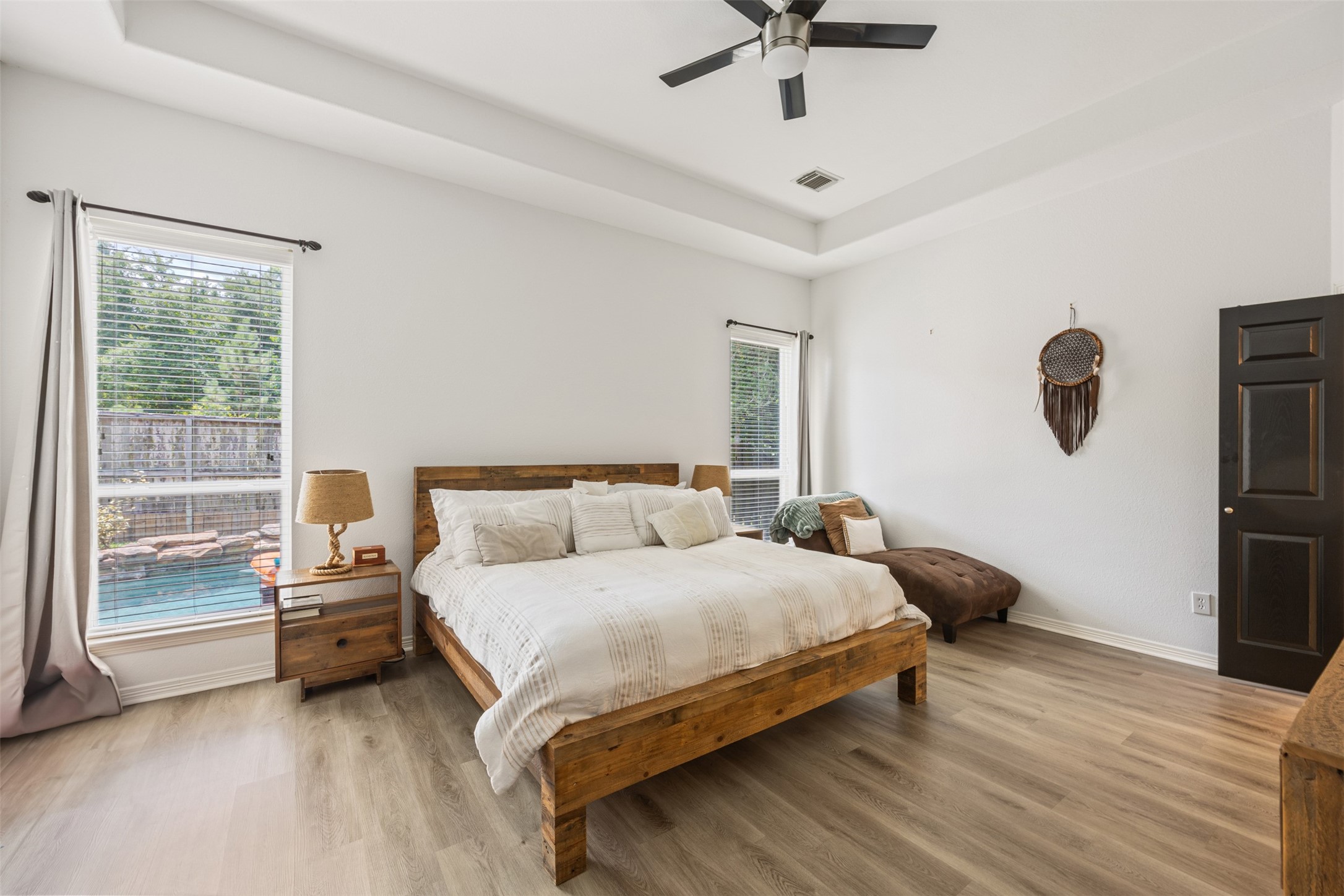 58 South Longsford Circle Spring, TX 77382 - Photo 38 of 50 a bedroom with a bed and a chandelier