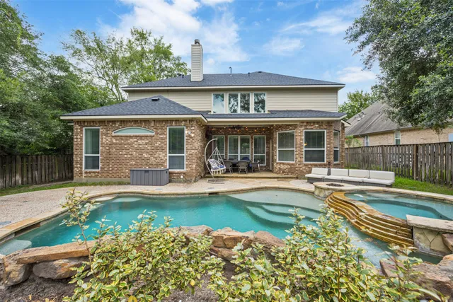 front view of a house with swimming pool and a yard