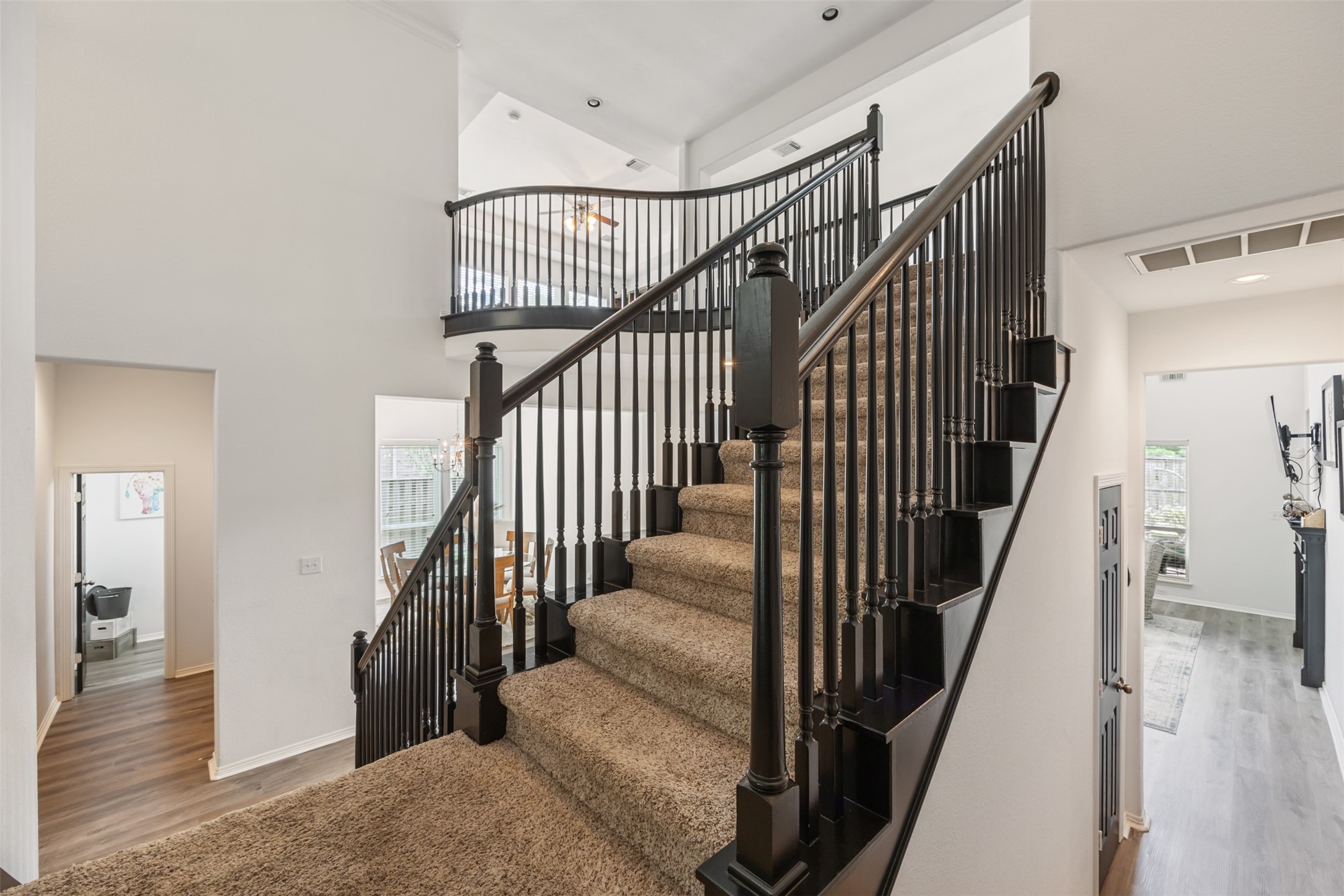 58 South Longsford Circle Spring, TX 77382 - Photo 8 of 50 a view of staircase with lots of frames on wall and wooden floor